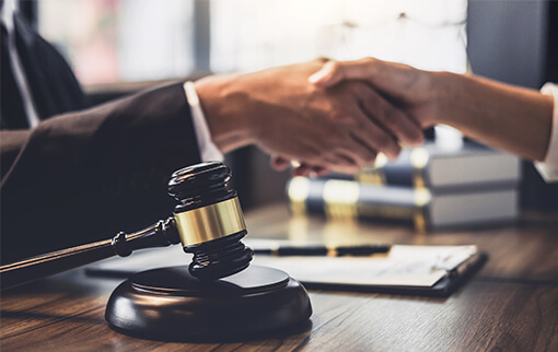 Photo of an attorney and a client shaking hands