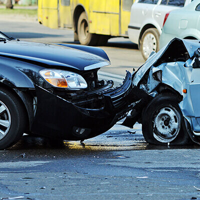 Photo of two cars after a head one collision in the middle of the road
